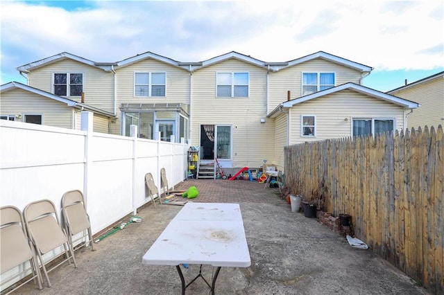 exterior space with a patio area and a fenced backyard