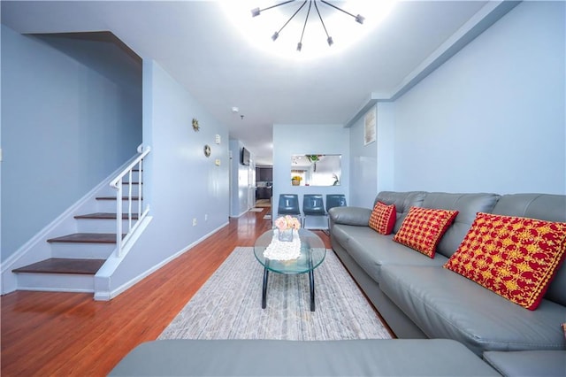 living area with stairs, wood finished floors, and baseboards