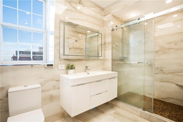 bathroom with vanity, plenty of natural light, and walk in shower