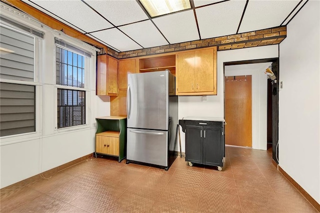 kitchen with stainless steel refrigerator and light tile patterned floors