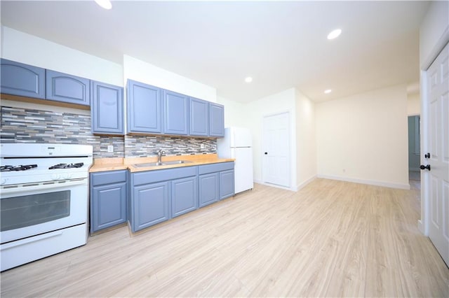 kitchen with white appliances, backsplash, sink, light hardwood / wood-style flooring, and butcher block countertops