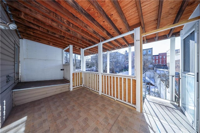 unfurnished sunroom with lofted ceiling