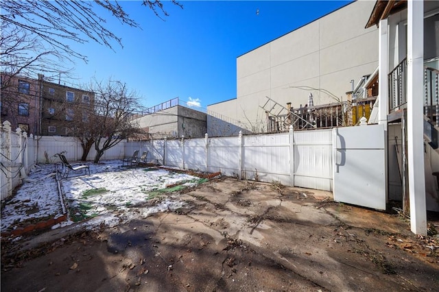 yard covered in snow featuring a patio area