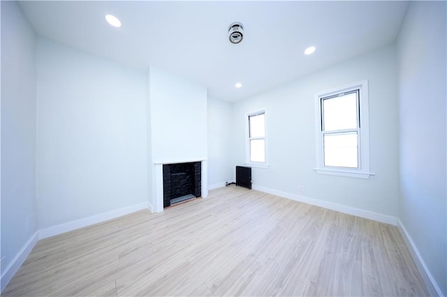 unfurnished living room featuring light hardwood / wood-style flooring