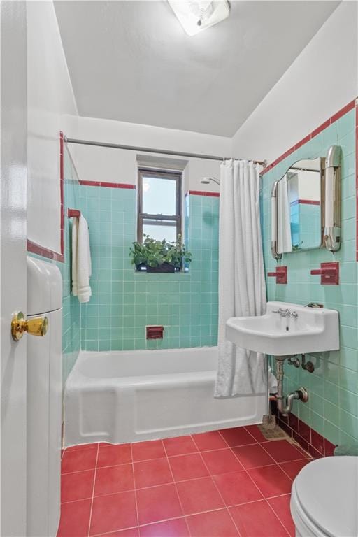 full bathroom with tile patterned floors, toilet, sink, tile walls, and shower / bath combination with curtain