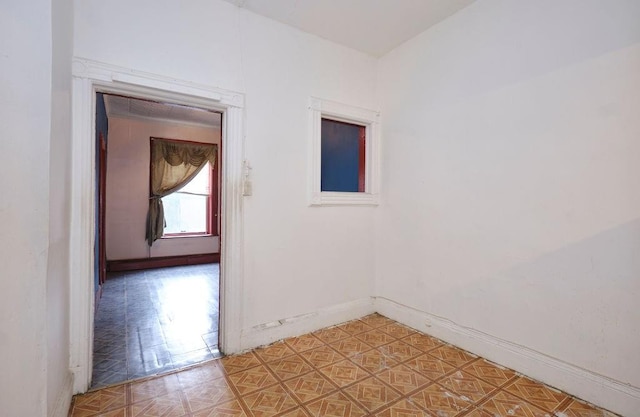 empty room with parquet flooring