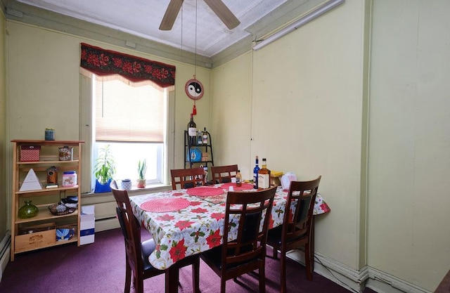 dining room with baseboard heating, ceiling fan, and dark colored carpet