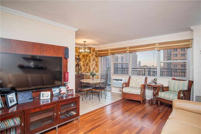 living room with a notable chandelier, a wall mounted AC, ornamental molding, and wood-type flooring