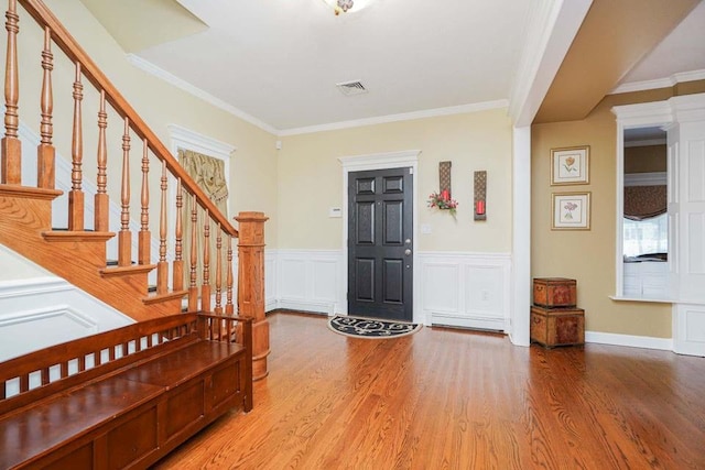 foyer featuring crown molding and hardwood / wood-style floors