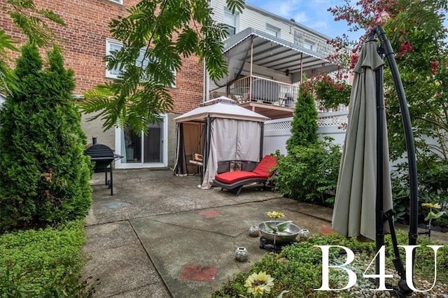 view of patio / terrace with grilling area and fence