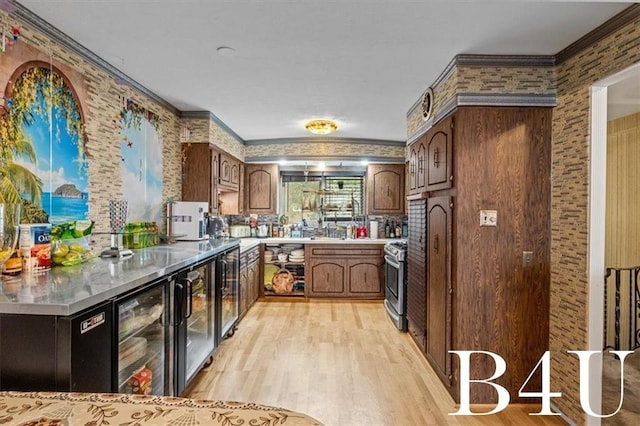 kitchen with stainless steel range with gas cooktop, wine cooler, crown molding, stainless steel countertops, and light wood-type flooring