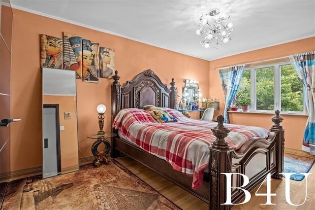 bedroom with a chandelier, baseboards, and wood finished floors