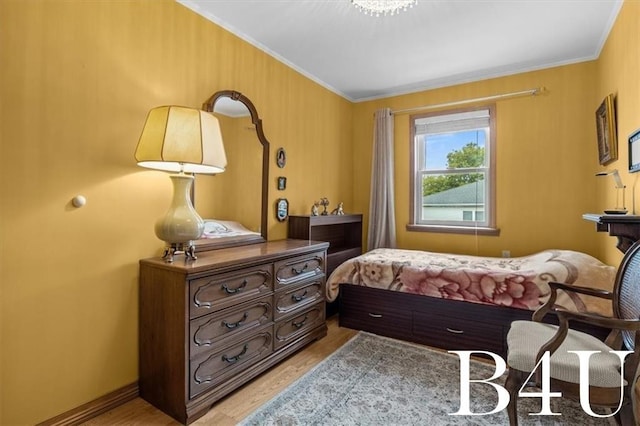 bedroom with light wood finished floors and ornamental molding