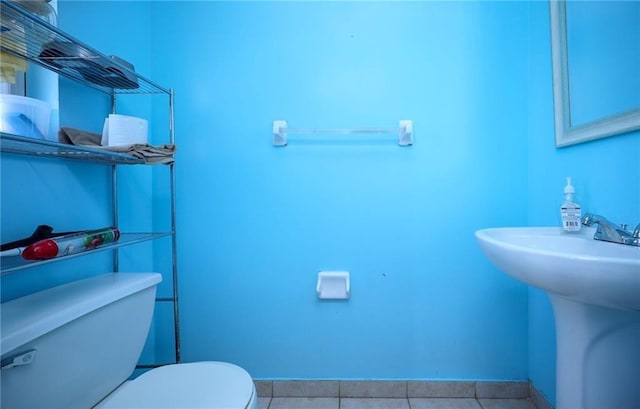 bathroom with tile patterned floors, toilet, and sink