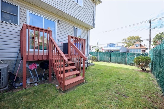 exterior space featuring a wooden deck, a yard, and central air condition unit