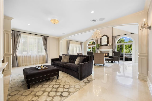 living room with crown molding, decorative columns, visible vents, vaulted ceiling, and a lit fireplace