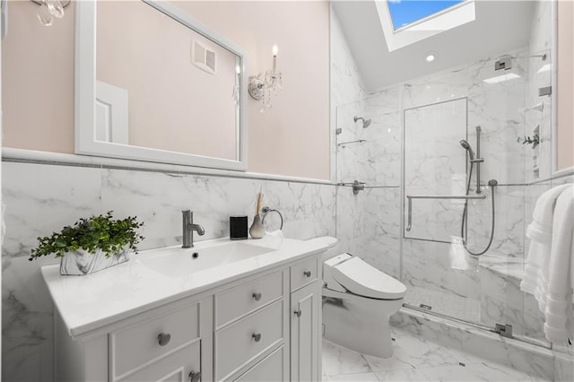 full bath with toilet, a skylight, visible vents, vanity, and marble finish floor