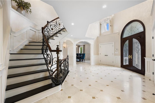 entrance foyer featuring ornate columns and french doors