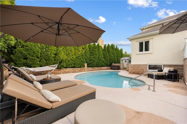 outdoor pool featuring a patio and an outdoor hangout area