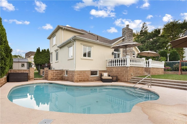 outdoor pool featuring fence