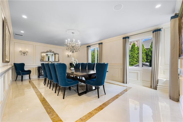 dining space featuring a chandelier, marble finish floor, recessed lighting, and a decorative wall