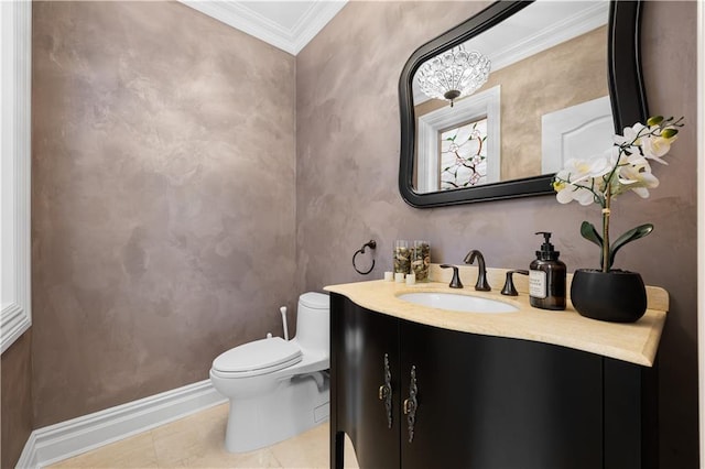 bathroom with toilet, ornamental molding, vanity, tile patterned flooring, and baseboards