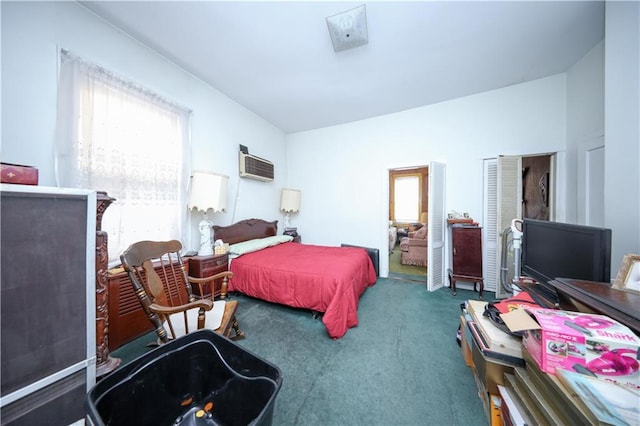 bedroom with a wall unit AC and carpet