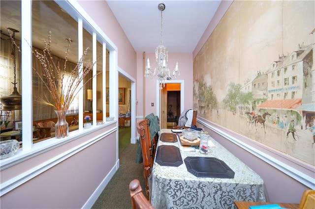 carpeted dining space featuring a notable chandelier