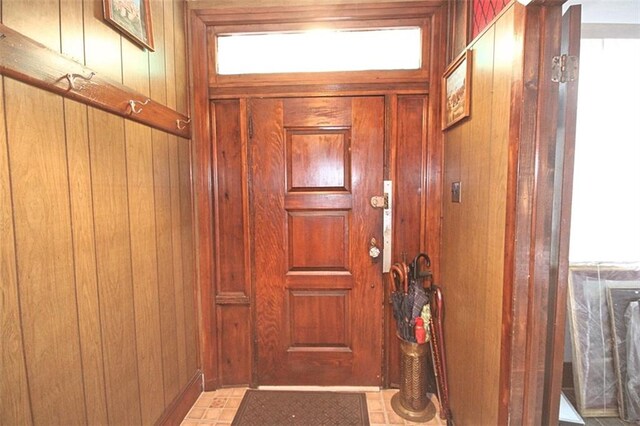 doorway featuring wooden walls