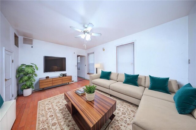 living room with ceiling fan and wood-type flooring