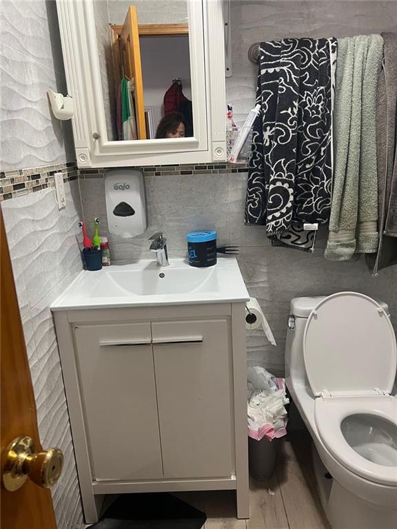 bathroom featuring vanity and toilet