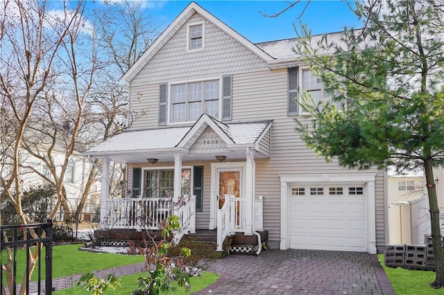 view of front of property with a garage and a front yard