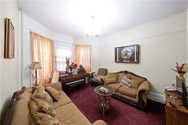 living room featuring dark carpet and a chandelier