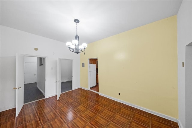 interior space featuring a notable chandelier and baseboards