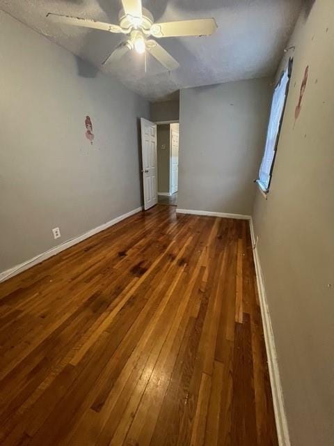 1241 E 98th St, Brooklyn, NY 11236 - unfurnished bedroom featuring wood-type flooring, baseboards, and a ceiling fan
