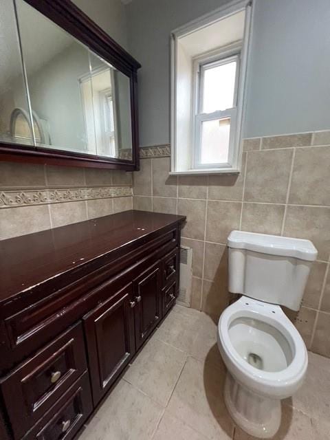1241 E 98th St, Brooklyn, NY 11236 - bathroom with toilet, vanity, tile walls, wainscoting, and tile patterned floors