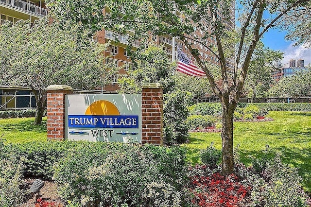 community / neighborhood sign with a lawn