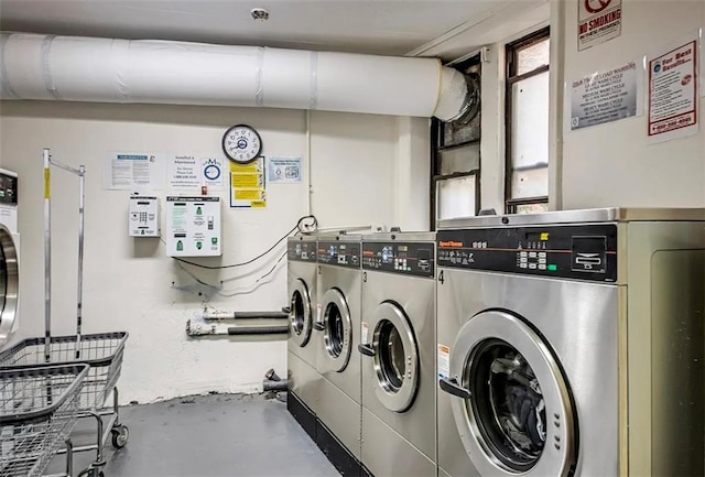 clothes washing area featuring washer and dryer