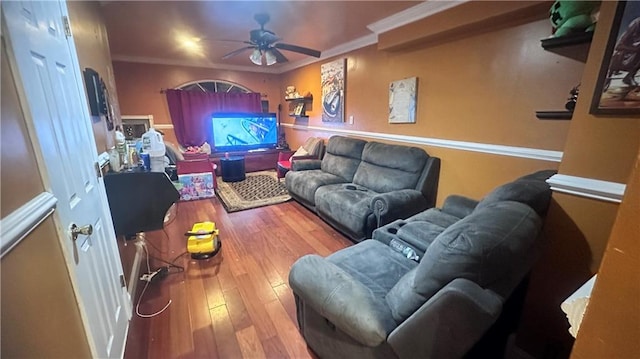 living room with hardwood / wood-style floors, ceiling fan, and ornamental molding