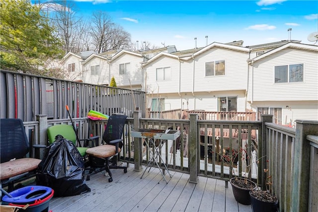 deck with a residential view and fence