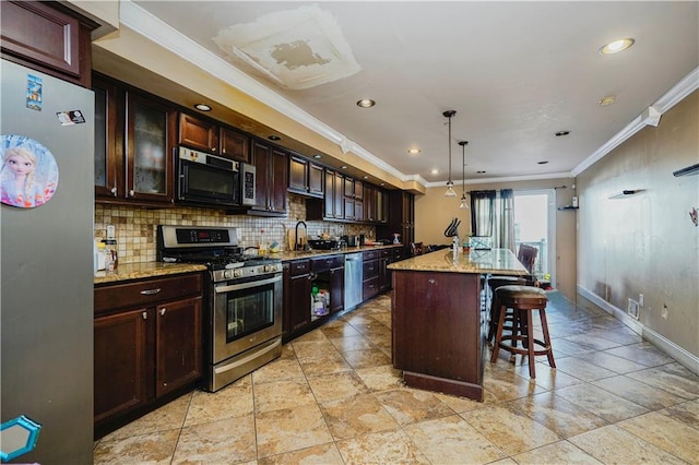kitchen with a kitchen breakfast bar, tasteful backsplash, appliances with stainless steel finishes, baseboards, and ornamental molding