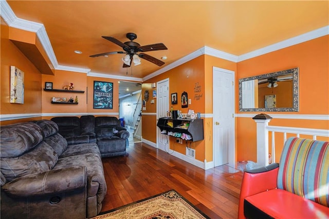 living area with hardwood / wood-style flooring, crown molding, baseboards, and ceiling fan