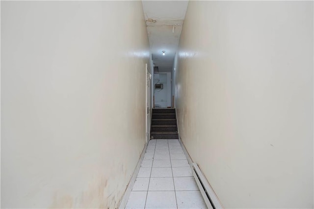 hall featuring light tile patterned flooring and a baseboard radiator
