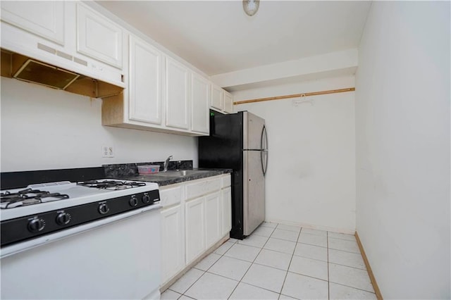 kitchen with white cabinetry, a sink, freestanding refrigerator, under cabinet range hood, and white gas stove