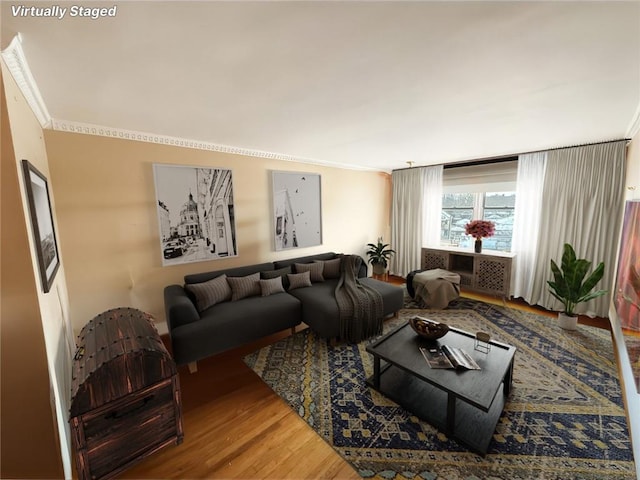 living room with hardwood / wood-style floors and crown molding