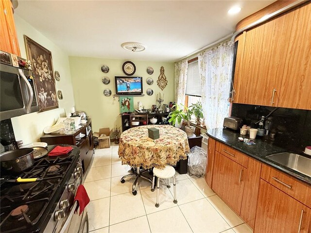 laundry area featuring separate washer and dryer and light tile patterned floors