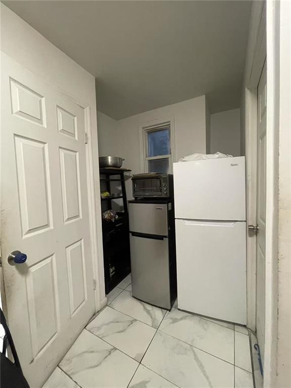 kitchen with stainless steel fridge and white refrigerator