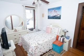 bedroom with ceiling fan and wood-type flooring