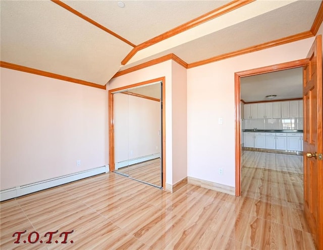 unfurnished bedroom with lofted ceiling, crown molding, a baseboard radiator, and a closet