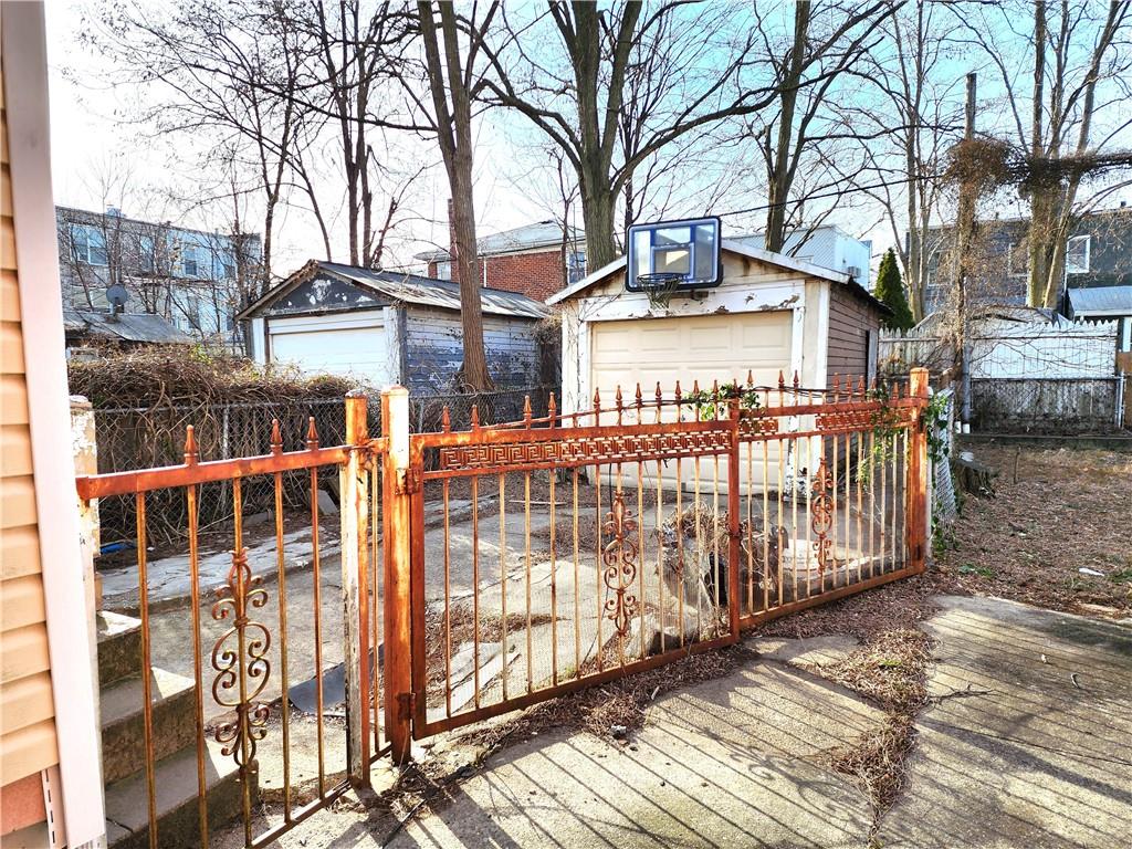 wooden terrace with an outbuilding and a garage